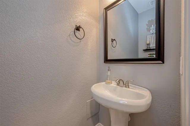 a bathroom with a sink and mirror