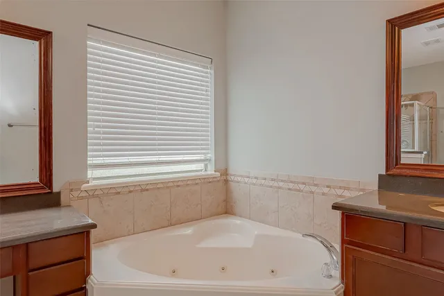 a white bath tub sitting next to a window
