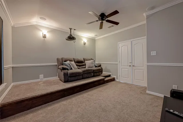 a living room with furniture and a ceiling fan