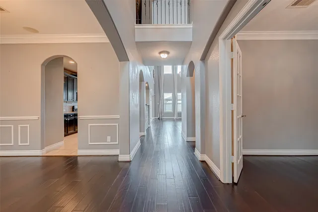 a view of a hallway with wooden floor and staircase