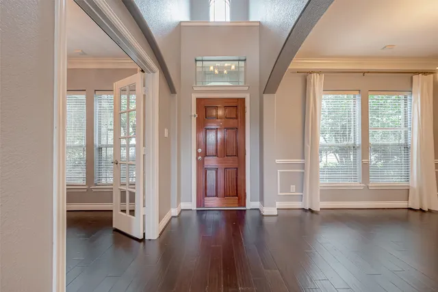 a view of an entryway with wooden floor and windows