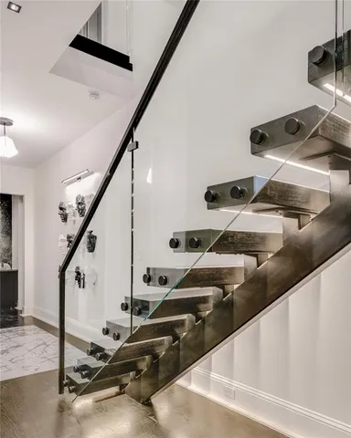 a bathroom with a granite countertop sink a refrigerator and a mirror