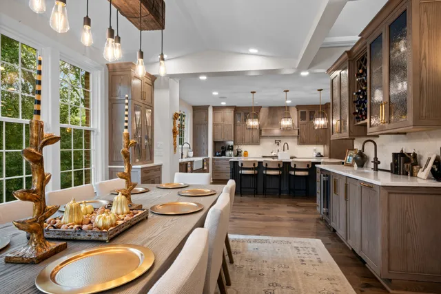 a large kitchen with kitchen island granite countertop a large counter top space a sink stainless steel appliances and cabinets