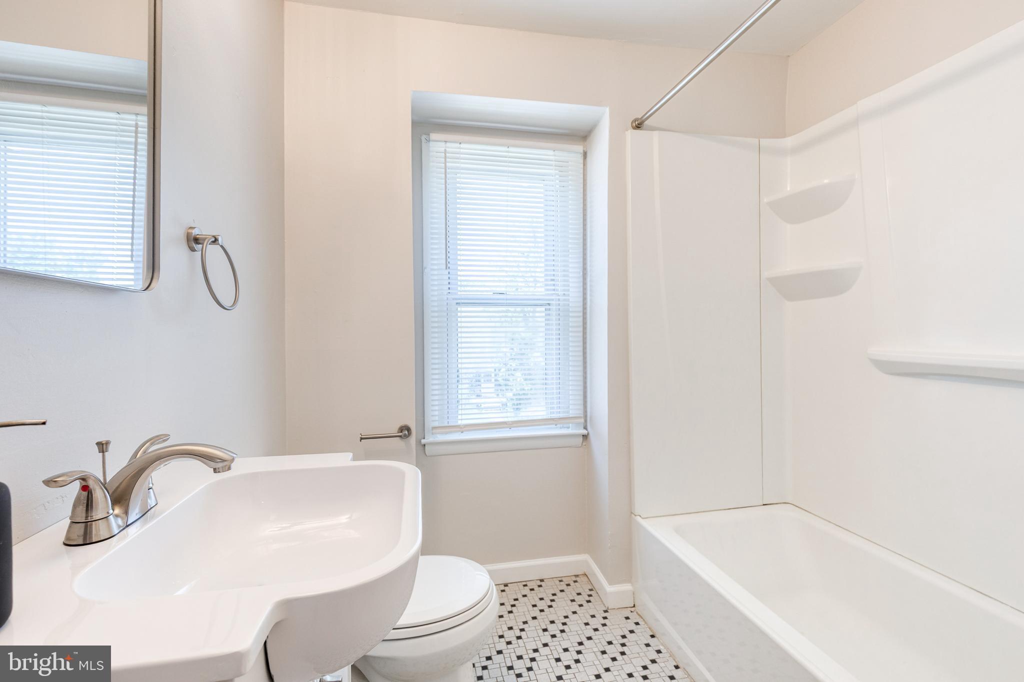 5649 Utrecht Road Baltimore, MD 21206 - Photo 31 of 42 a bathroom with a sink a toilet and tub