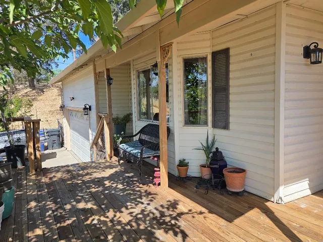 a view of a chairs and table in backyard of the house