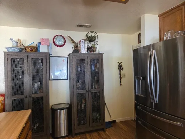 a kitchen with a refrigerator and cabinets