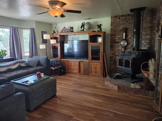 a living room with furniture flat screen tv and a fireplace