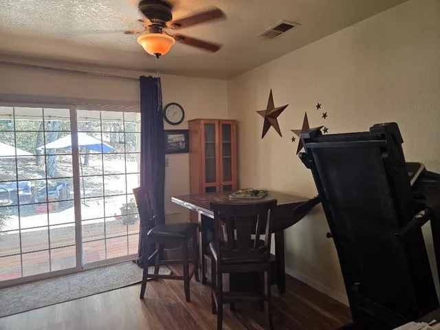 a view of a workspace with furniture and a window