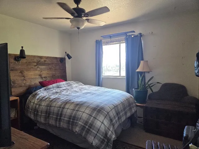 a bedroom with a bed and a window