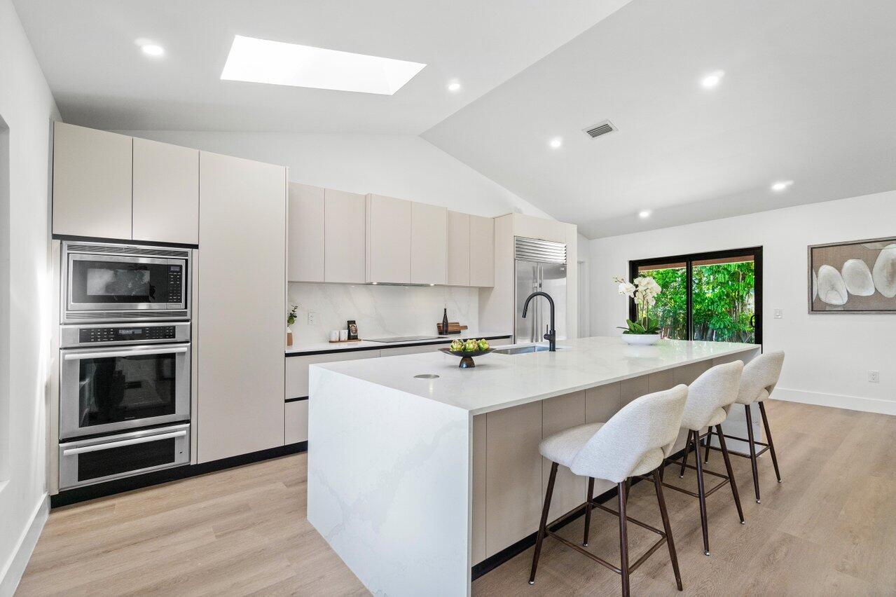 4408 Nicole Circle Tequesta, FL 33469 - Photo 13 of 29 a kitchen with a stove a sink and a refrigerator