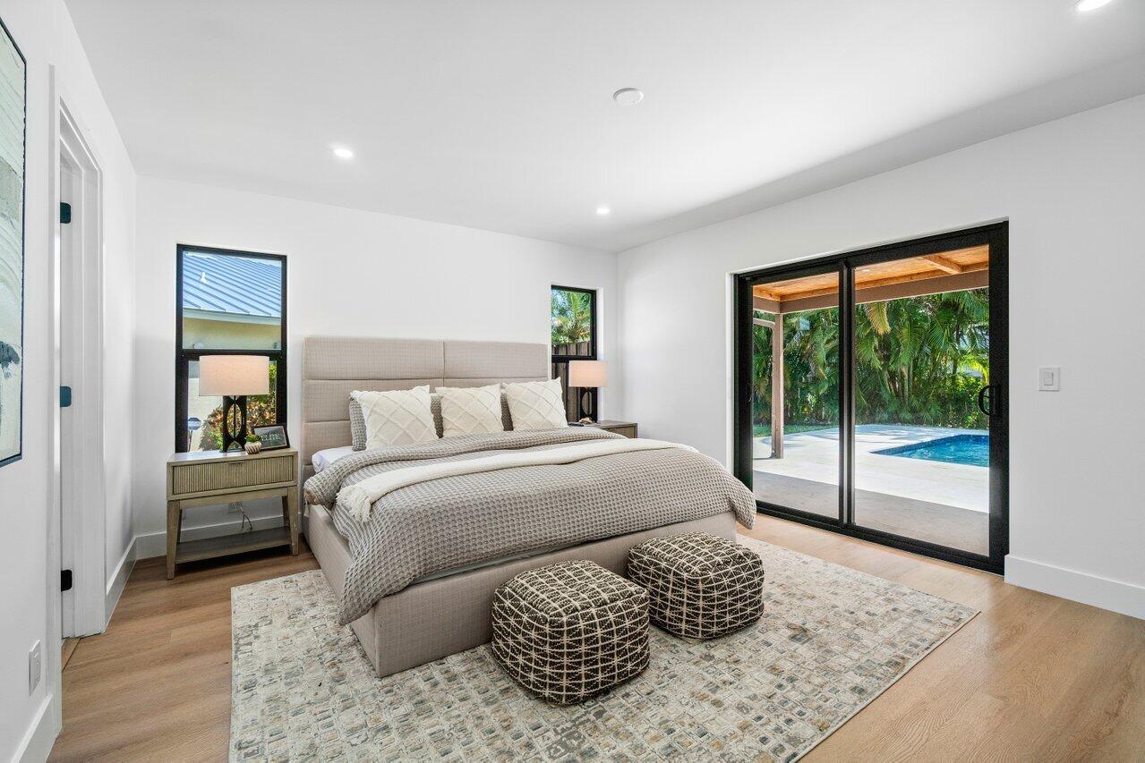 4408 Nicole Circle Tequesta, FL 33469 - Photo 15 of 29 a bedroom with a bed and glass window