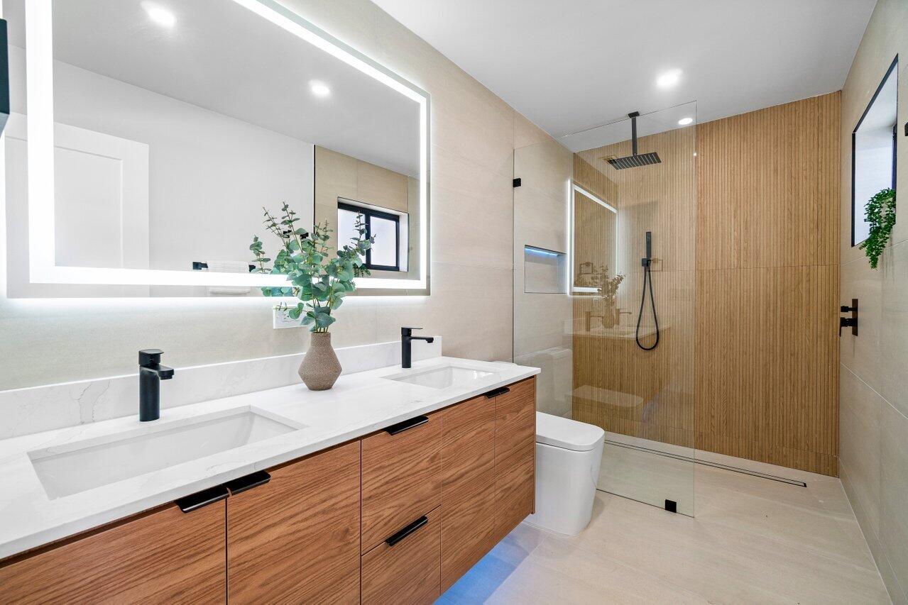 4408 Nicole Circle Tequesta, FL 33469 - Photo 19 of 29 a bathroom with a sink a toilet a mirror and shower