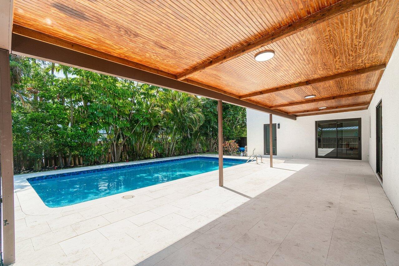 4408 Nicole Circle Tequesta, FL 33469 - Photo 25 of 29 a view of a backyard with a swimming pool