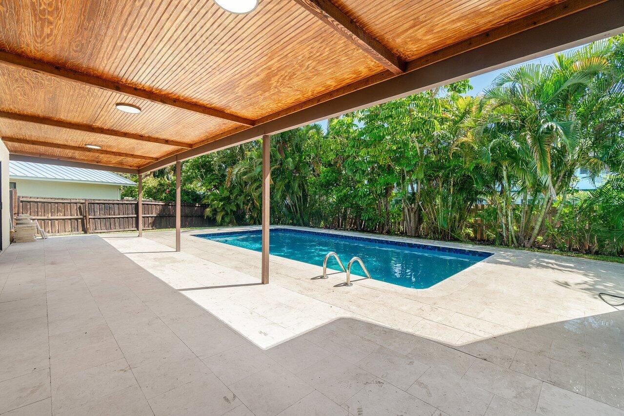 4408 Nicole Circle Tequesta, FL 33469 - Photo 26 of 29 a view of a backyard with a swimming pool