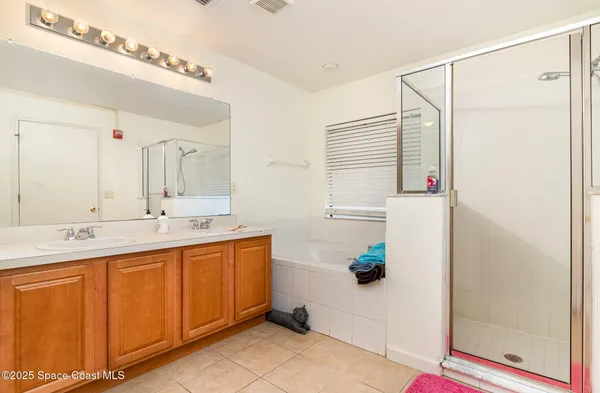 a bathroom with a double vanity sink and a mirror