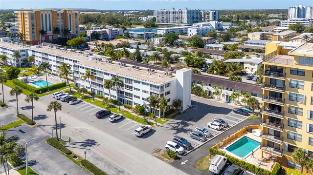a kitchen with stainless steel appliances granite countertop a refrigerator a sink and wooden cabinets