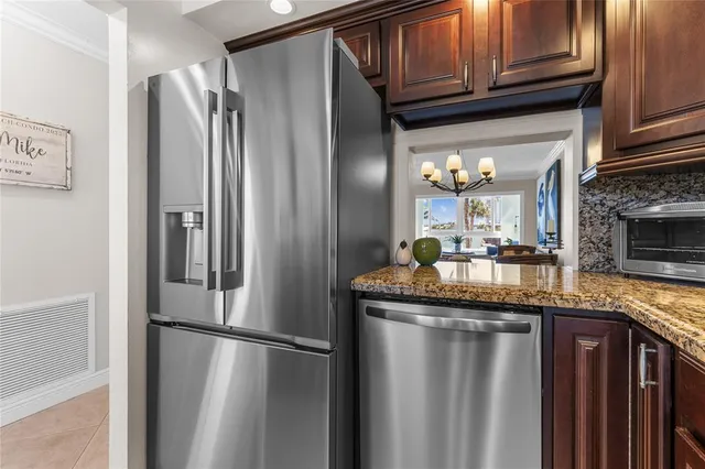a kitchen with stainless steel appliances granite countertop a sink stove and cabinets