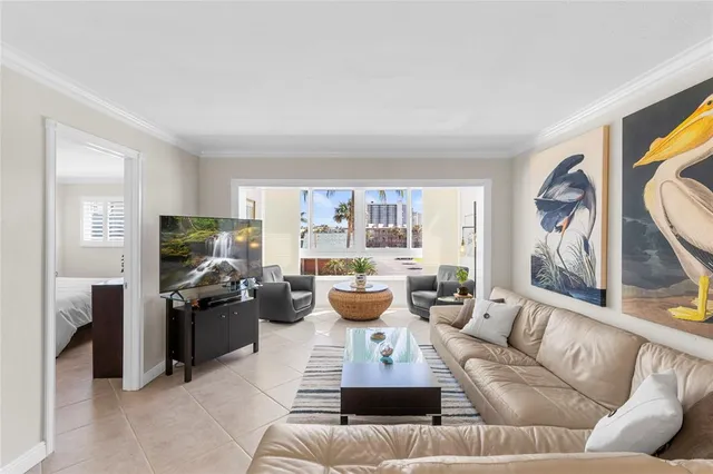 a living room with furniture and a dining table with rug