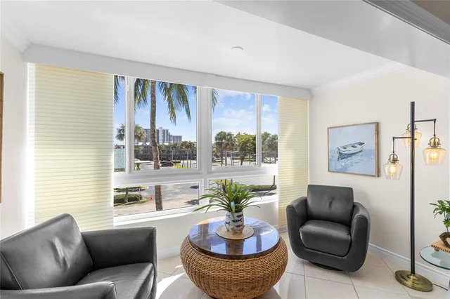a view of a dining room with furniture a chandelier and wooden floor