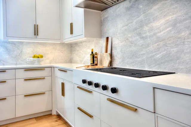 a kitchen with granite countertop cabinets and white appliances
