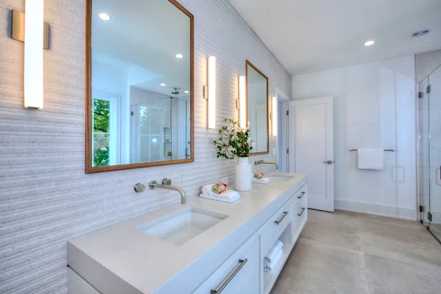 a bathroom with a sink a large mirror and a shower