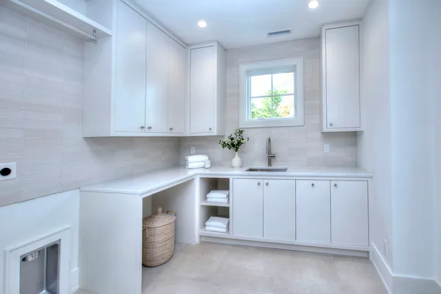 a kitchen with cabinets appliances and a window