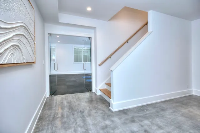 a view of entryway and hall with wooden floor