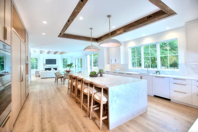 a kitchen with stainless steel appliances granite countertop lots of counter top space and wooden floors