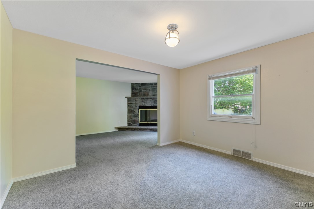 125 Circle Road Salina, NY 13212 - Photo 20 of 39 Primary bedroom with seating area, wood fireplace, double closets, & full bath.