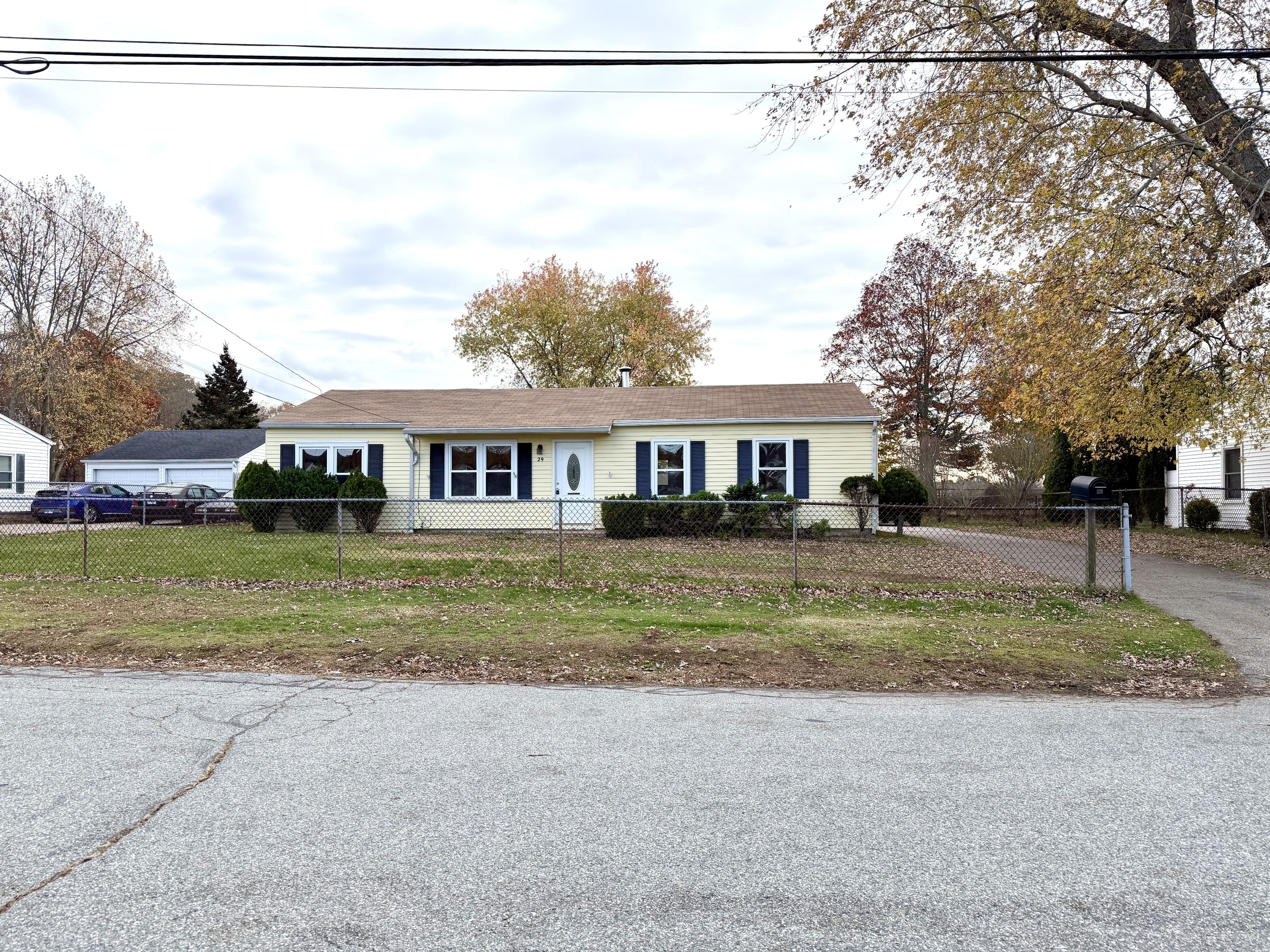 a front view of a house with a yard and trees