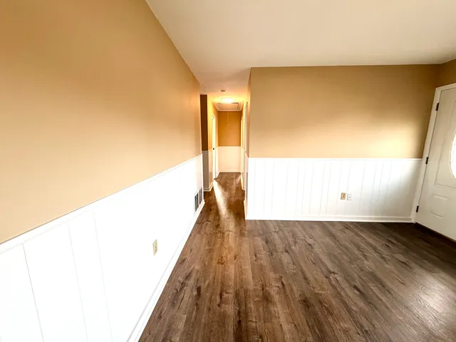 a view of a living room with wooden floor