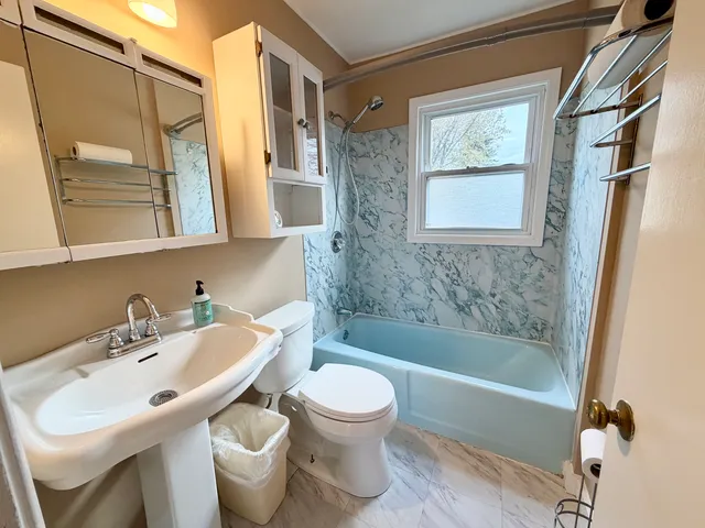a bathroom with a sink toilet and shower