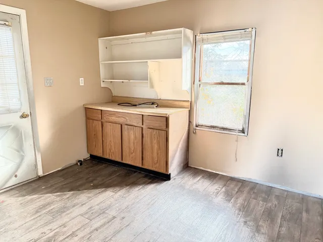a kitchen with a stove and a white cabinet