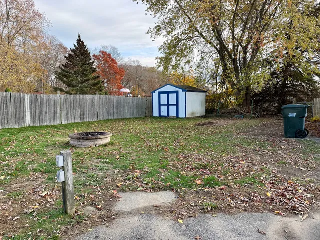 a view of a backyard with a tree
