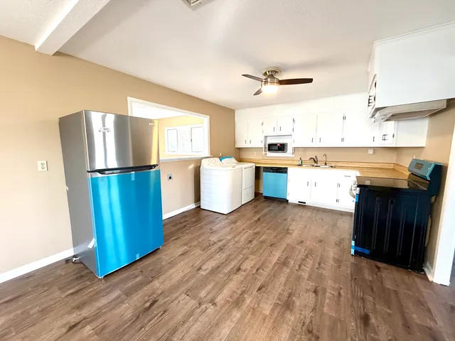 a kitchen with appliances and wooden cabinets