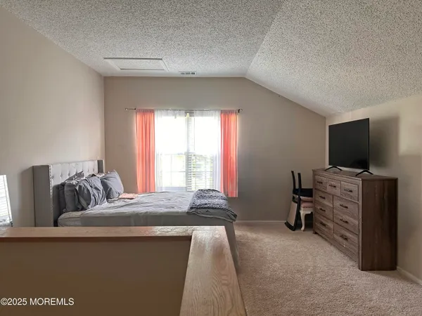 a bedroom with furniture and flat screen tv