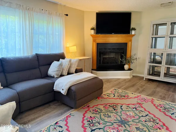 a bedroom with a bed a fireplace and a television