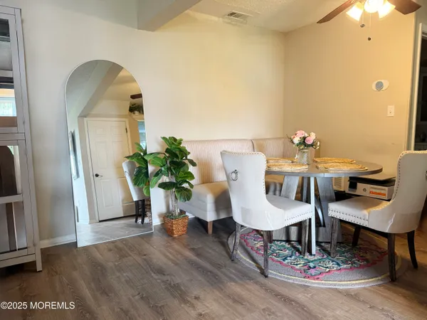 a view of a dining room with furniture and wooden floor