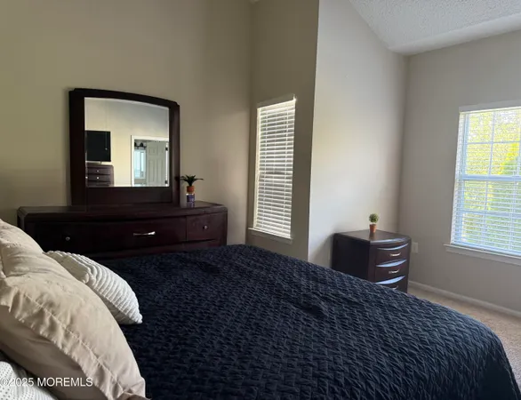 a bedroom with a bed and a closet with mirror