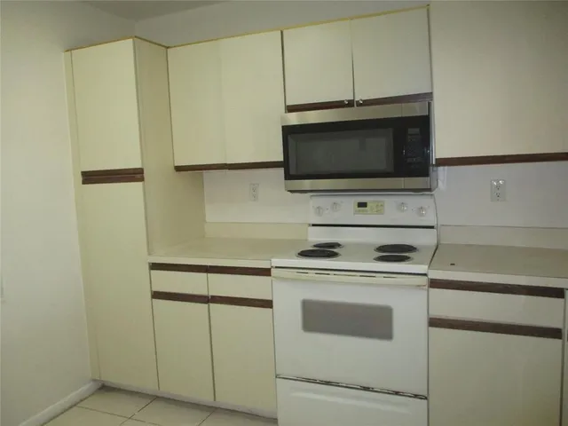 a kitchen with a stove and a microwave