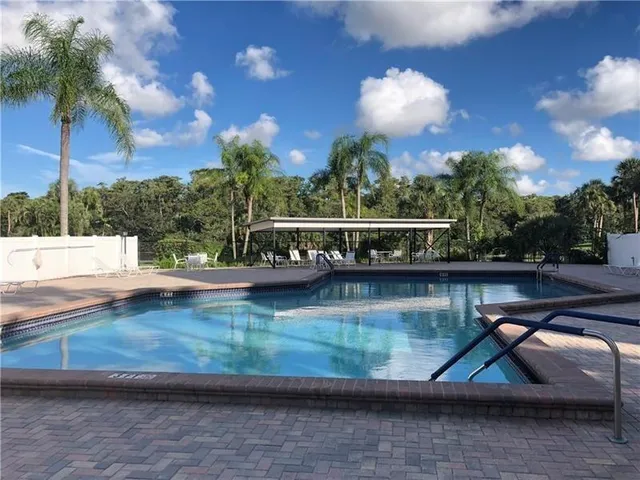 a view of balcony with wooden floor and fence