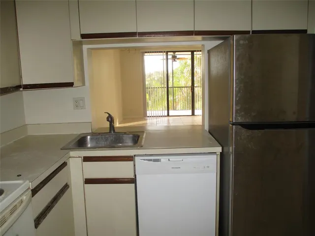 a kitchen with stainless steel appliances refrigerator and cabinets