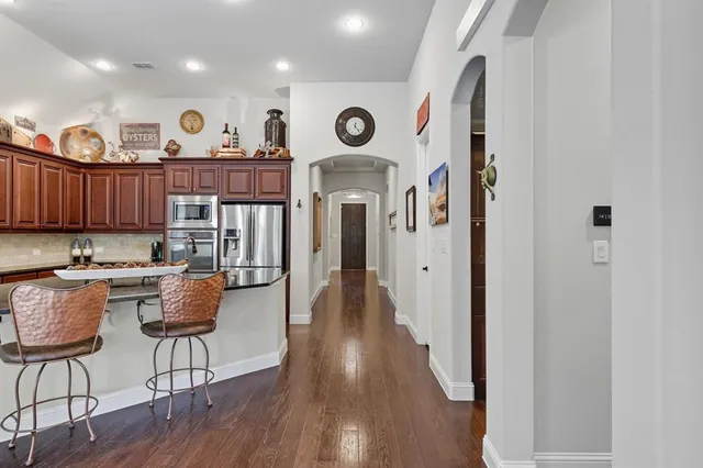 a view of a kitchen with furniture and wooden floor