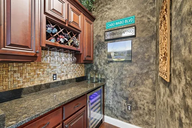 a bathroom with a granite countertop sink and a shower