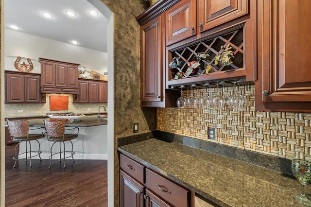a kitchen with a sink a stove and a wooden cabinets