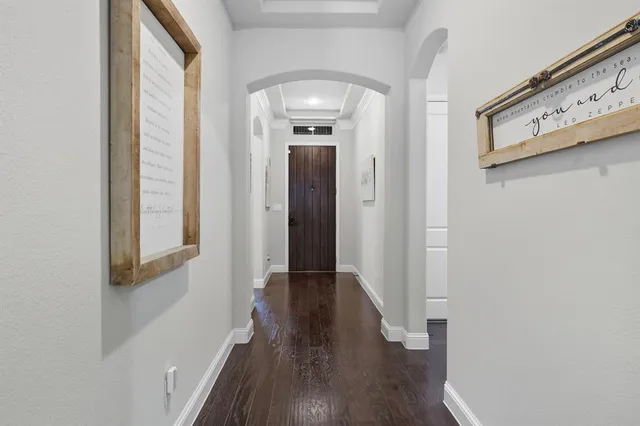 a view of hallway with wooden floor