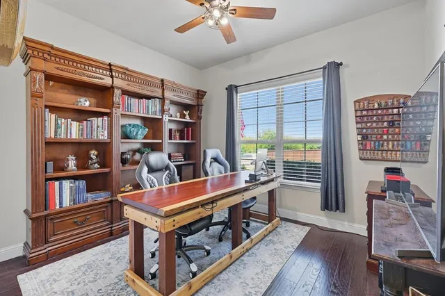 a living room with furniture and a book shelf