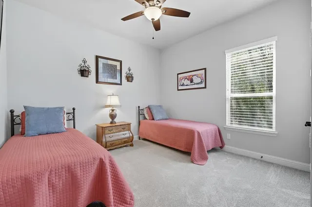 a spacious bedroom with two bed and window