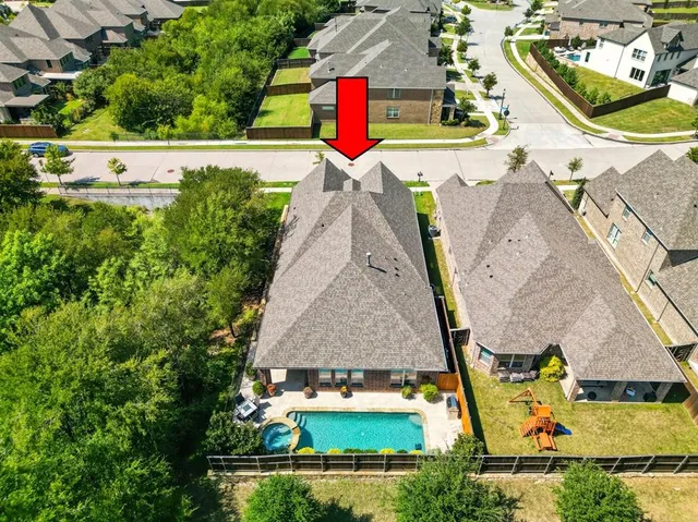 an aerial view of a house with a swimming pool