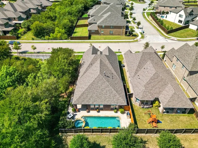 an aerial view of a house with a garden and swimming pool